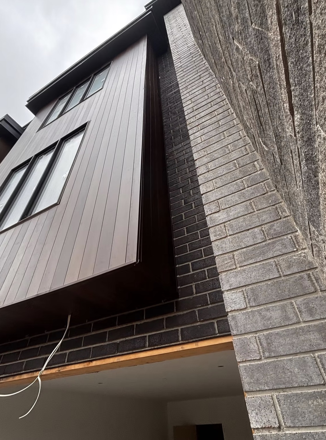 Close-up of a modern building exterior with dark vertical — European window and door project, Vireo Homes GTA