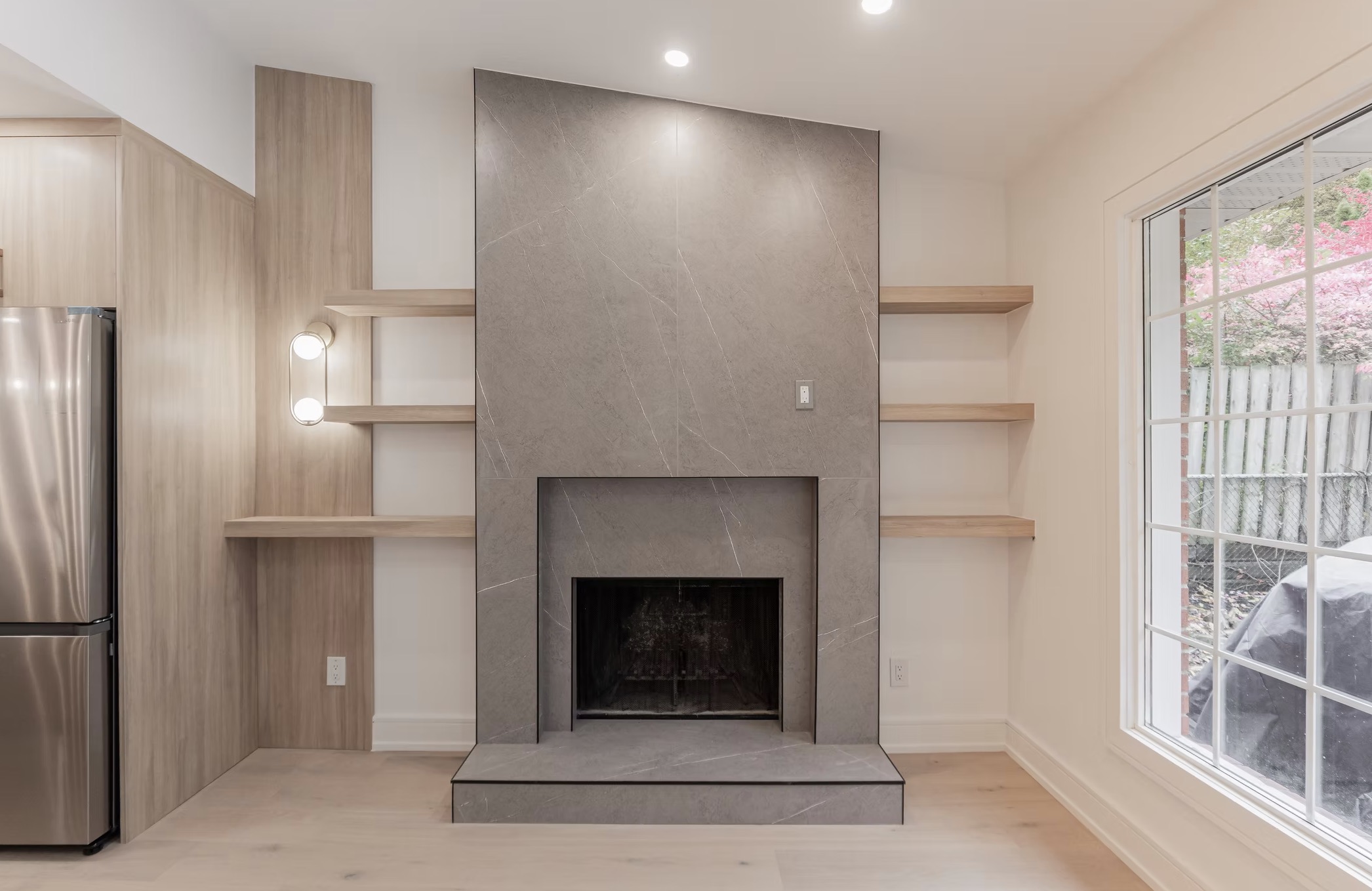 Modern living room featuring a gray tiled fireplace and — European window and door project, Vireo Homes GTA